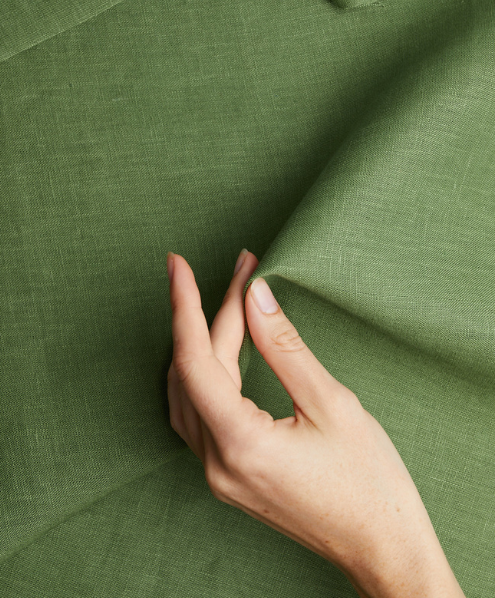 Draped Green Linen fabric with a hand by Circular Sourcing